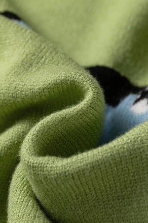 Green knit sweater with a blue and black abstract pattern, soft texture