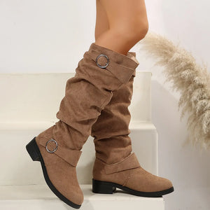Slouchy taupe knee-high boots with buckle detail and low heel.