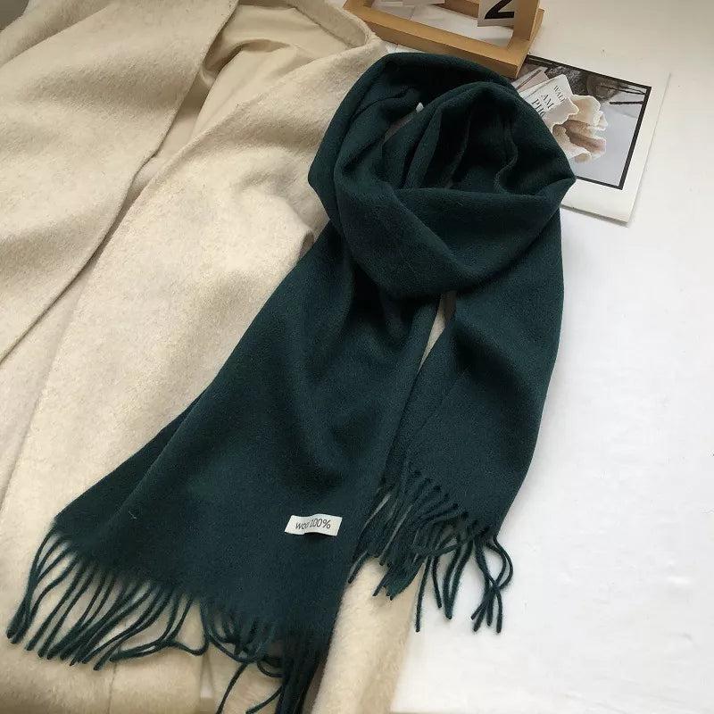 Luxurious wool knit scarf in Army Green with fringes and a "Wool 100%" tag.