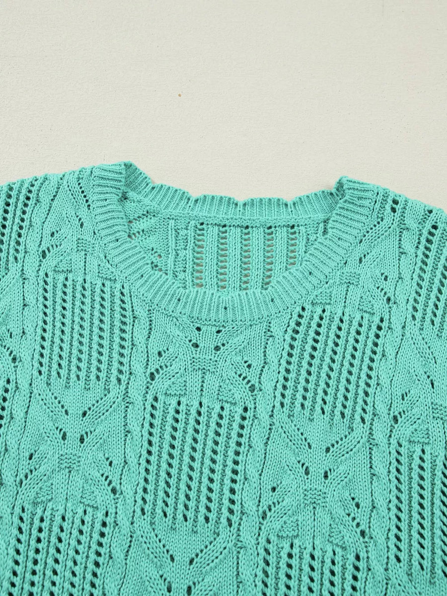 Teal pointelle knit sweater with scalloped trim and open knit details.