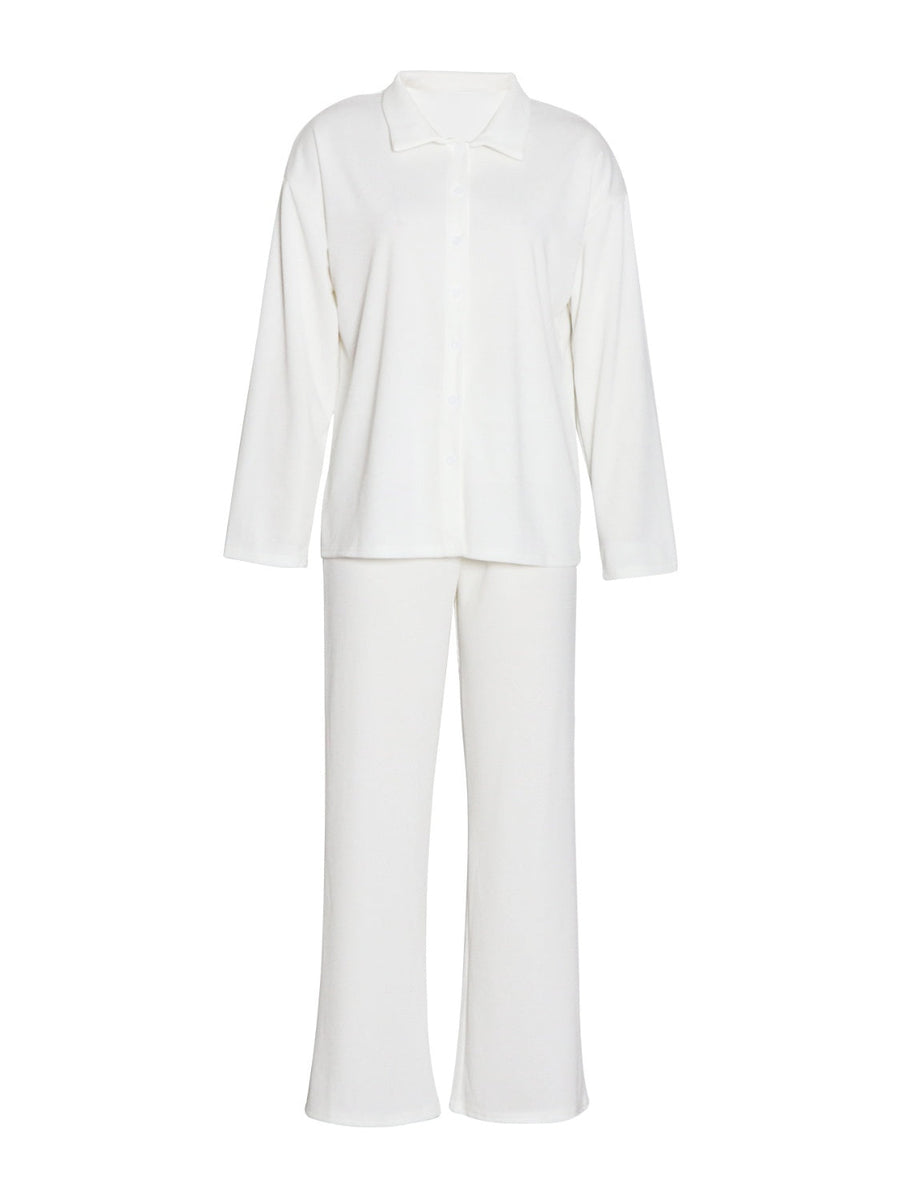 White ribbed knit loungewear set with buttoned collared shirt and relaxed fit pants.