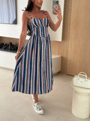 Midi dress with tie straps and a zigzag stripe pattern in blue, brown, and pink.