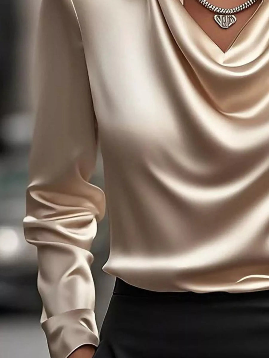 Tan satin cowl neck long-sleeve blouse with draped neckline and ruched cuffs.