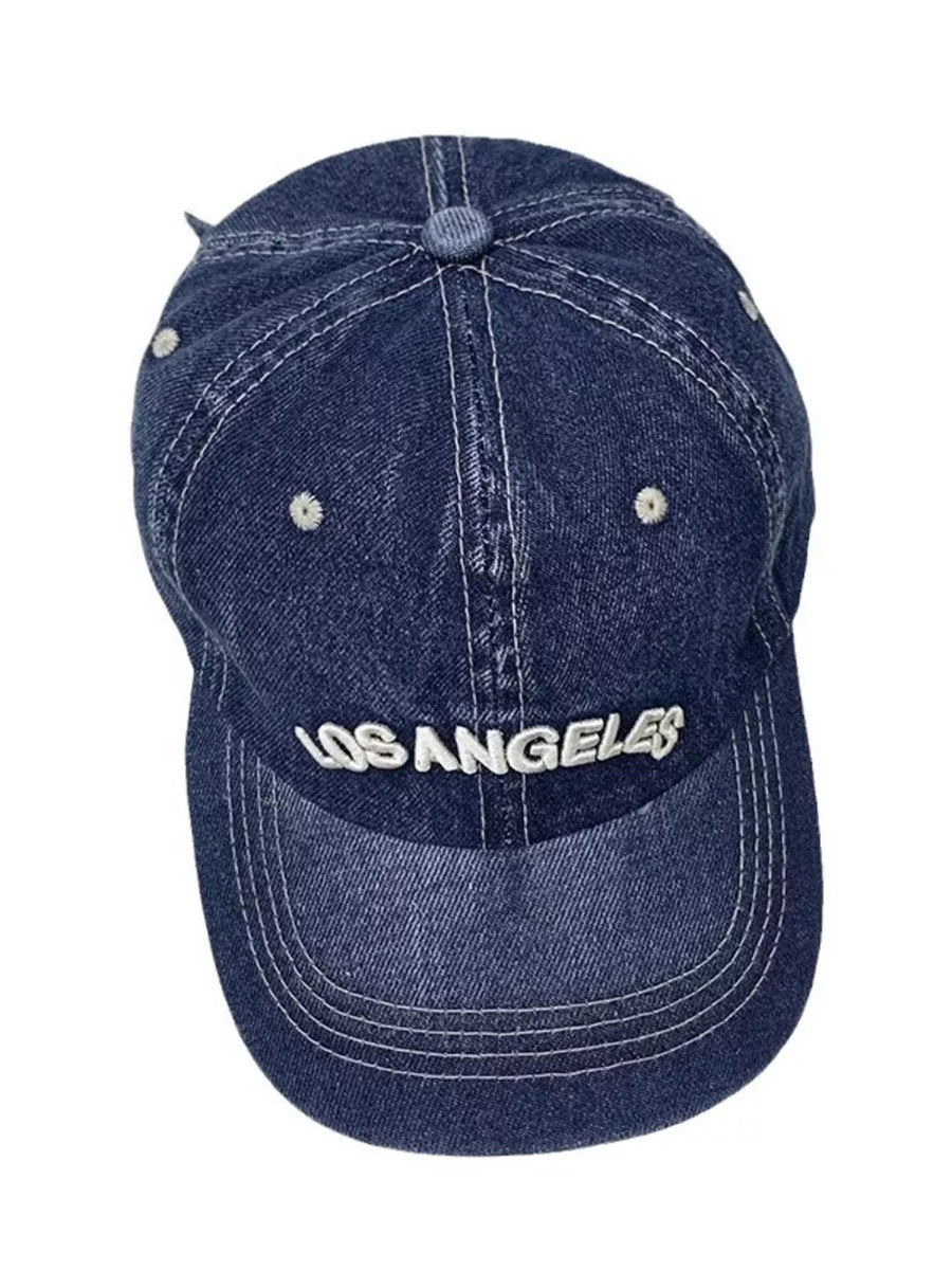 Dark blue denim baseball cap with white "Los Angeles" embroidery and contrast stitching.