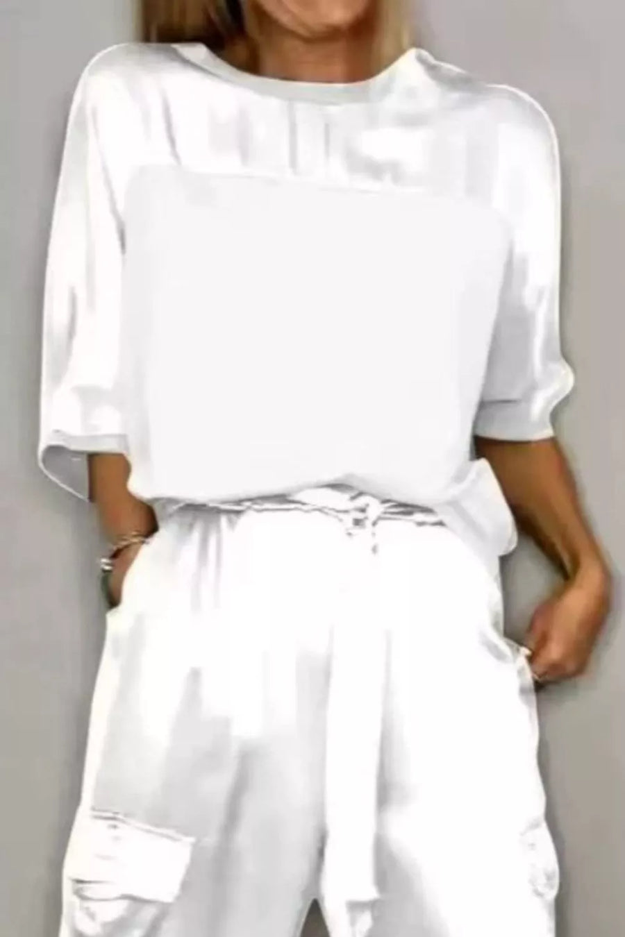 White satin two-piece ensemble with drawstring waist pants and a loose-fit top.