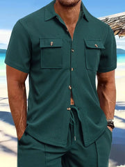 Dark green textured resort shirt with short sleeves and two patch pockets.