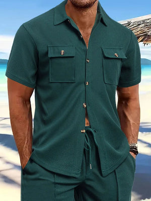 Dark green textured resort shirt with short sleeves and two patch pockets.