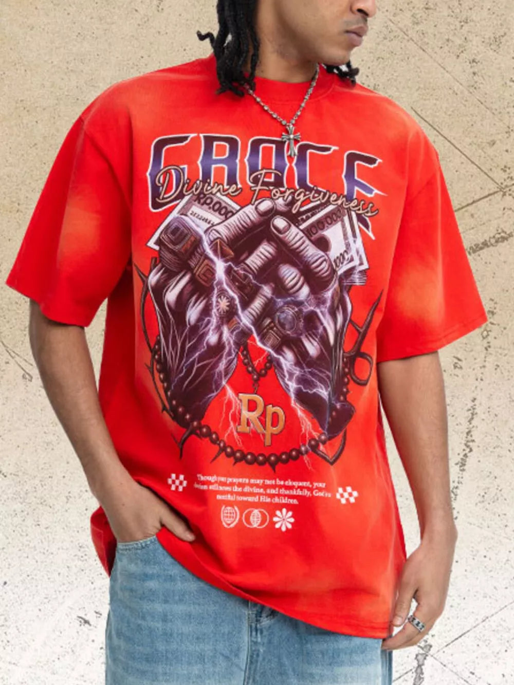 Red graphic t-shirt with short sleeves and crew neck, featuring praying hands holding money and lightning.