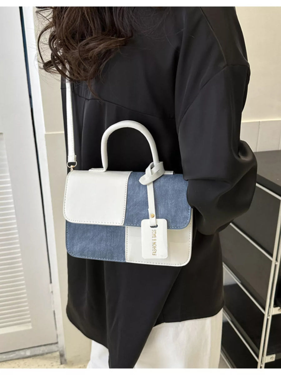 Chic two-tone PU leather crossbody bag in white and blue denim patchwork with top handle.