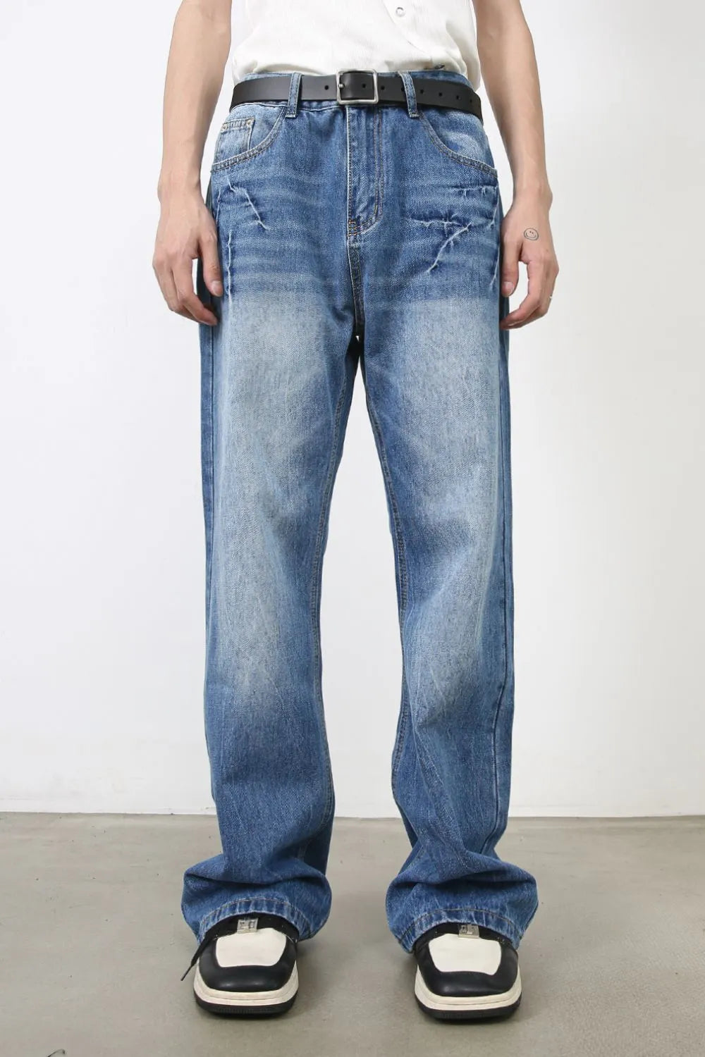 Baggy denim jeans in medium wash with distressed details and a relaxed fit.