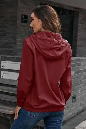 Burgundy hooded utility jacket with drawstring waist and elastic cuffs.