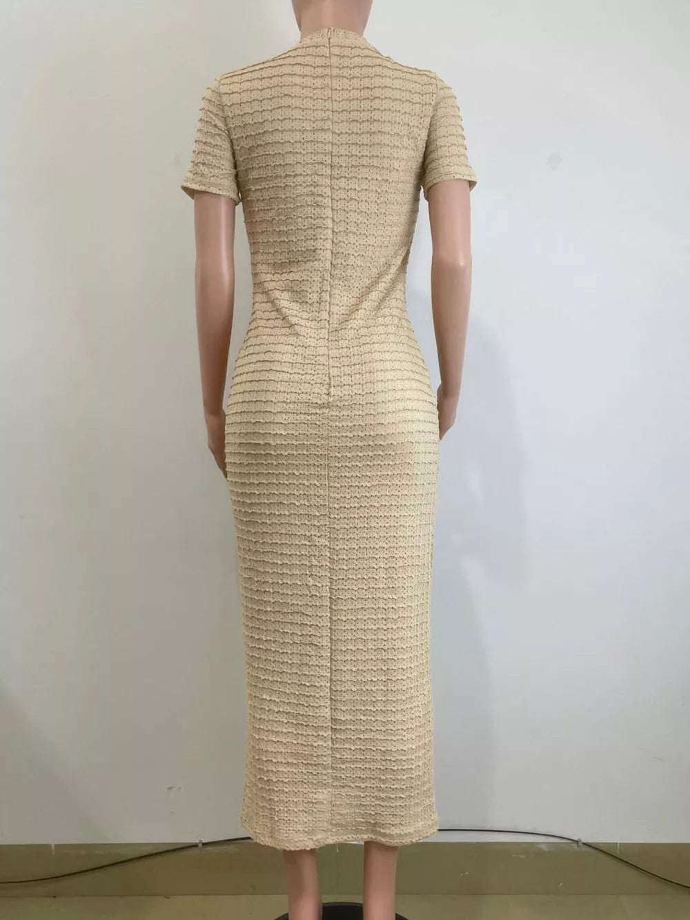 Khaki textured midi dress with short sleeves and a high neckline.
