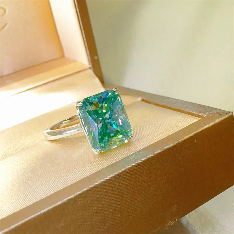 Emerald cut moissanite ring in silver with architectural design and bright brilliance.