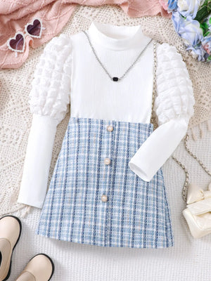 Baby girl's white puff sleeve top & blue plaid skirt set with pearl buttons.