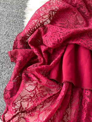 Red lace maxi dress with ruffled details and cutout accents.