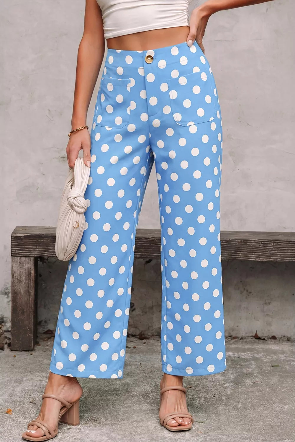 Blue polka dot cropped pants with pockets and a button closure.