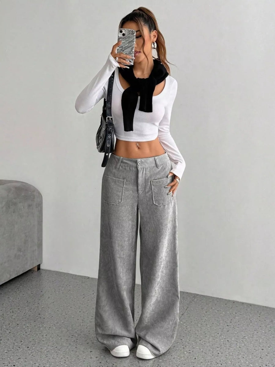 Chic grey corduroy wide-leg trousers with front pockets and a comfortable fit.