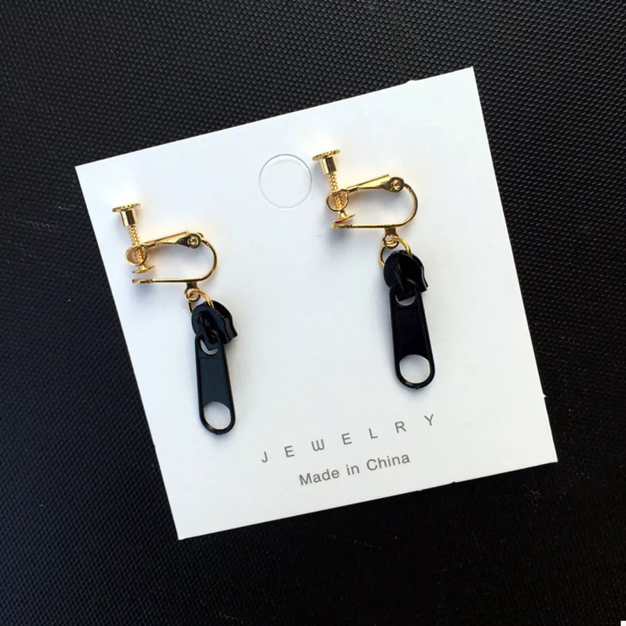 Black zipper dangle clip-on earrings with gold-tone hardware.