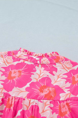 Vibrant floral print polyester blouse with ruffled mock neck and bubble sleeves.