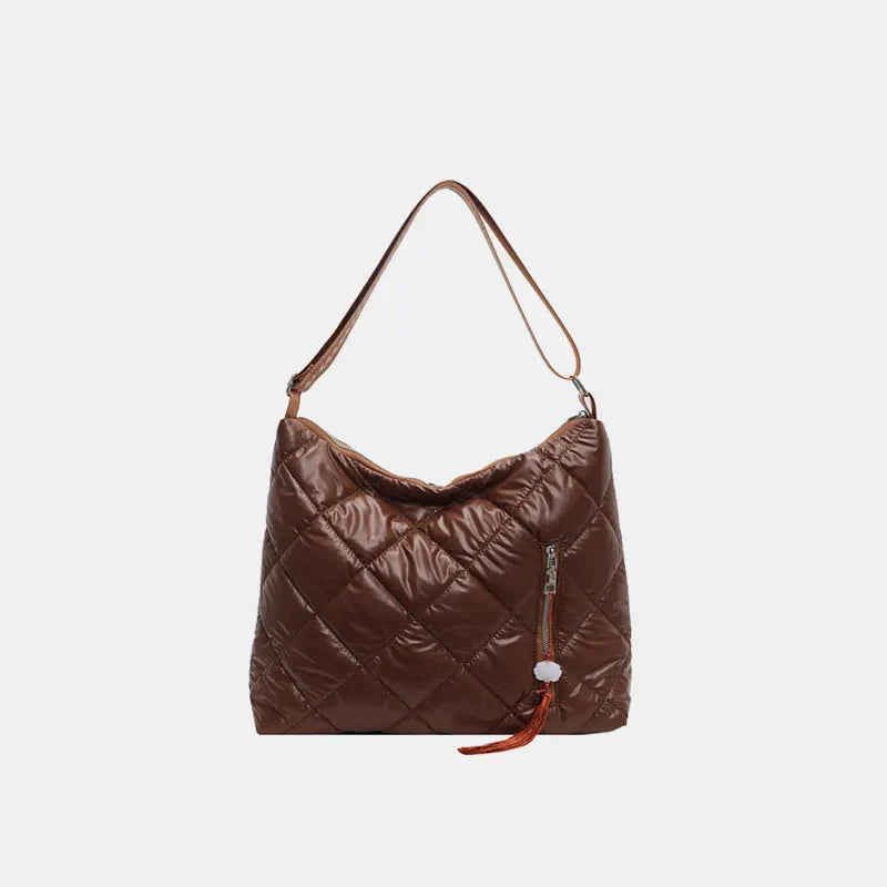 Brown diamond quilt padded shoulder bag with zipper pocket and tassel detail.