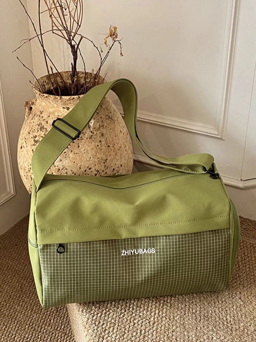 Green plaid Oxford travel bag with adjustable strap and logo detail