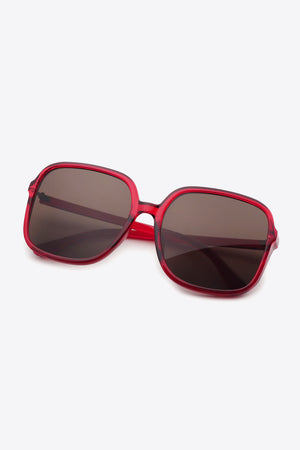 Red square frame sunglasses with dark lenses and a bold retro design.