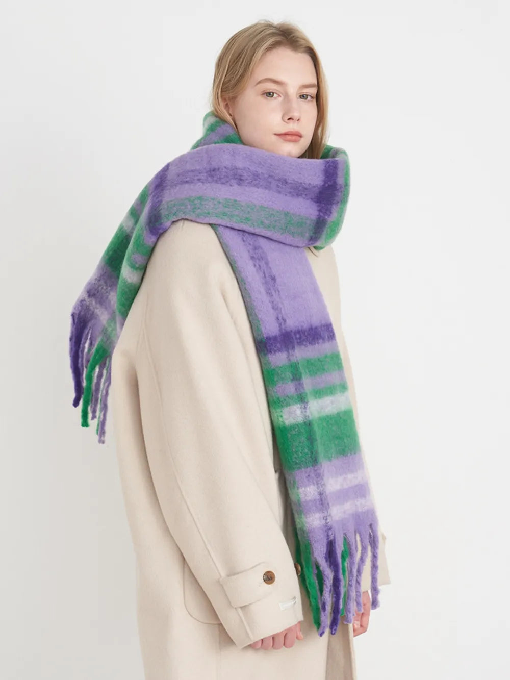 Textured plaid scarf in purple/white/green with fringe detail.