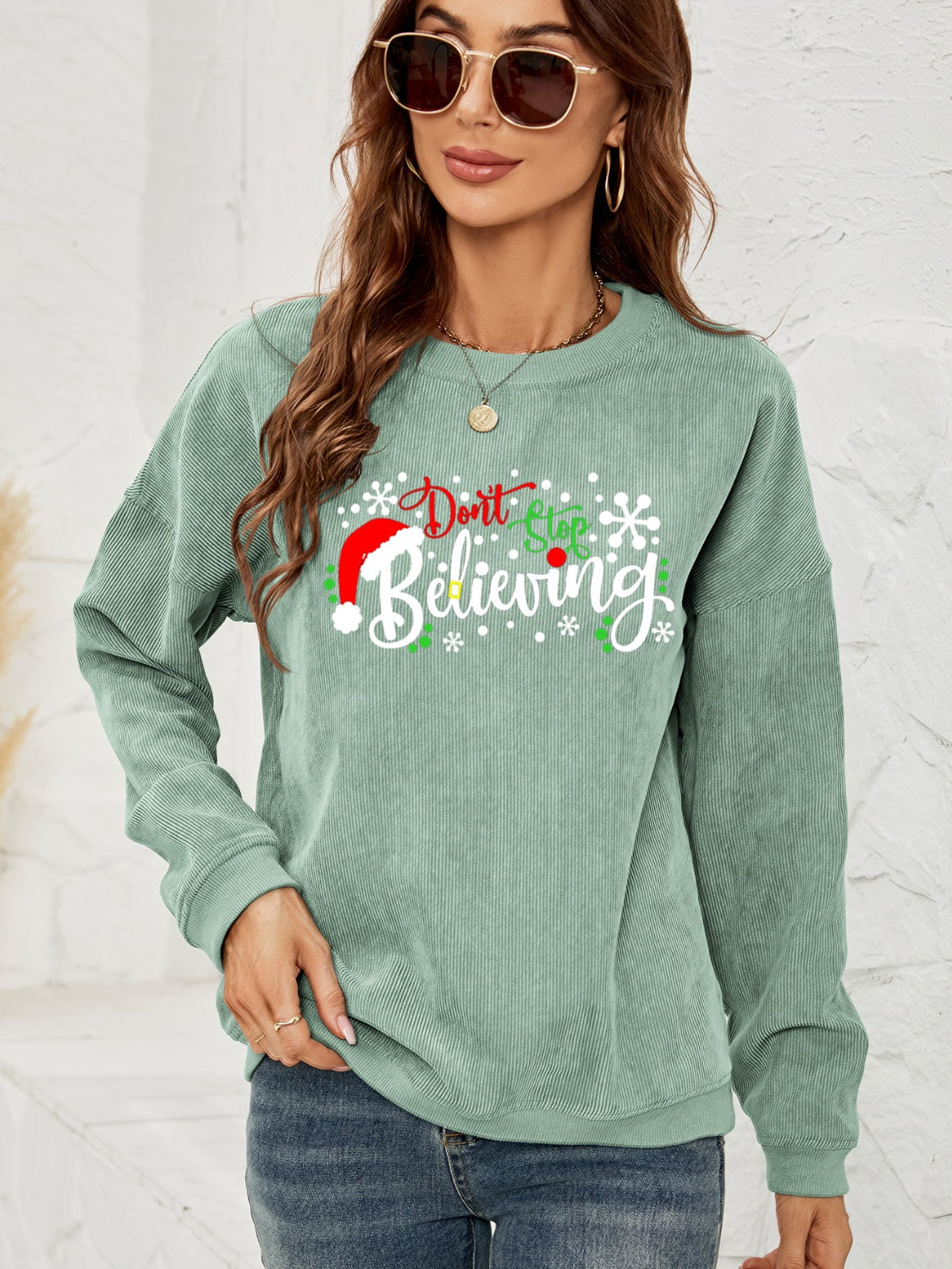 Sage corduroy crewneck sweatshirt with Christmas graphic and long sleeves.