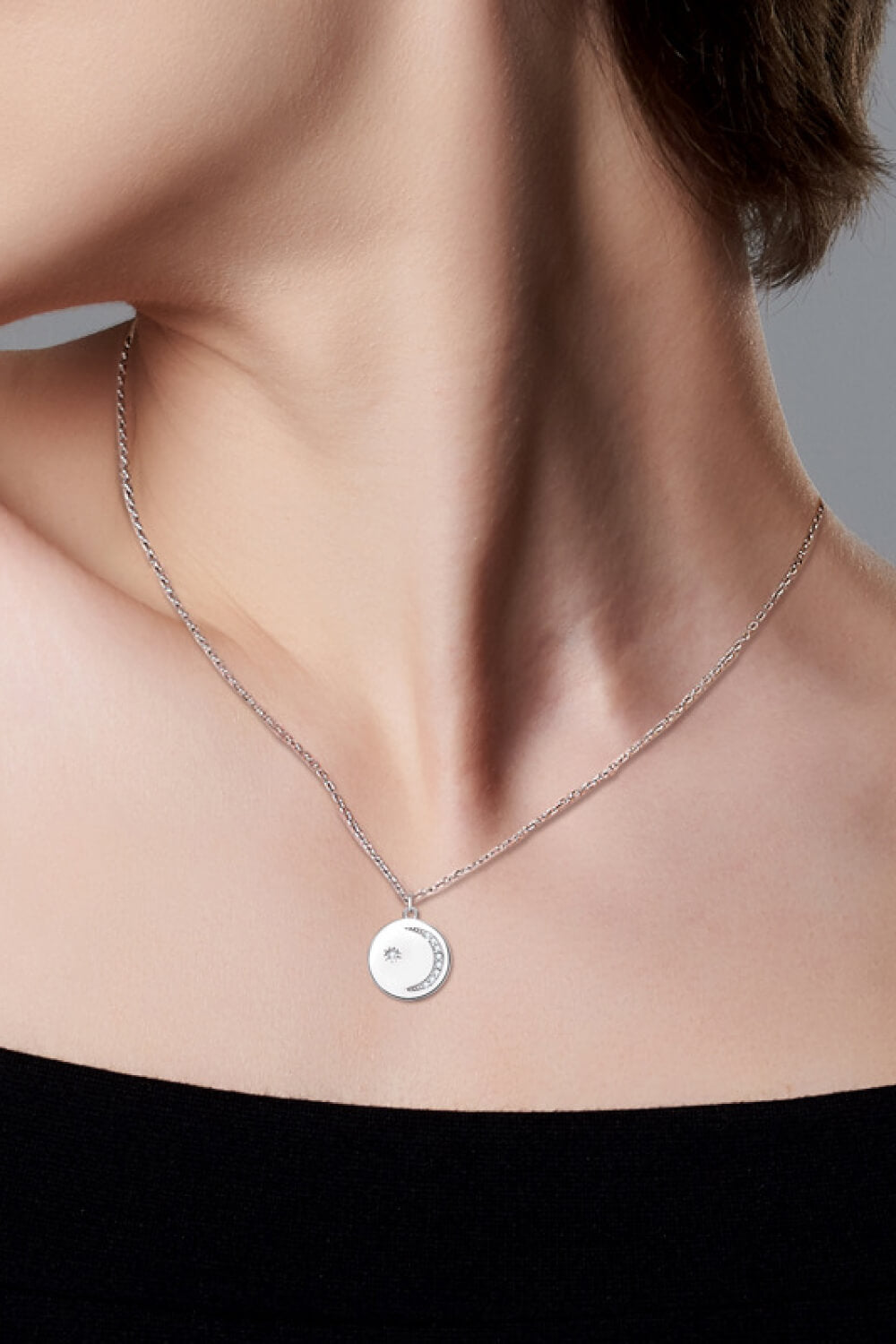Silver moon and star pendant necklace with pave crystals on a delicate chain