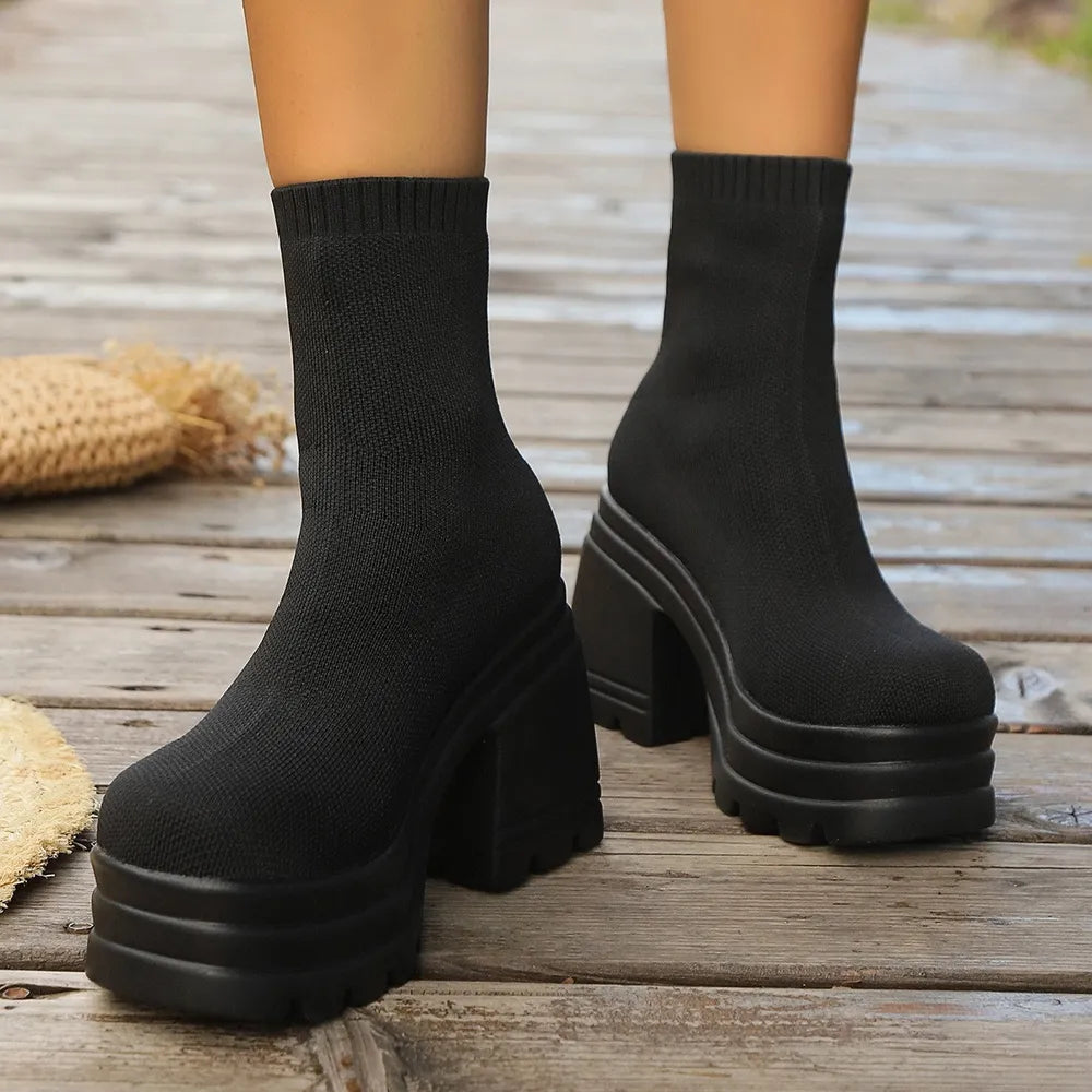 Black knit sock boots with chunky platform soles and block heels.
