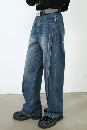 Medium wash denim jeans with wide legs and a vertical seam detail.