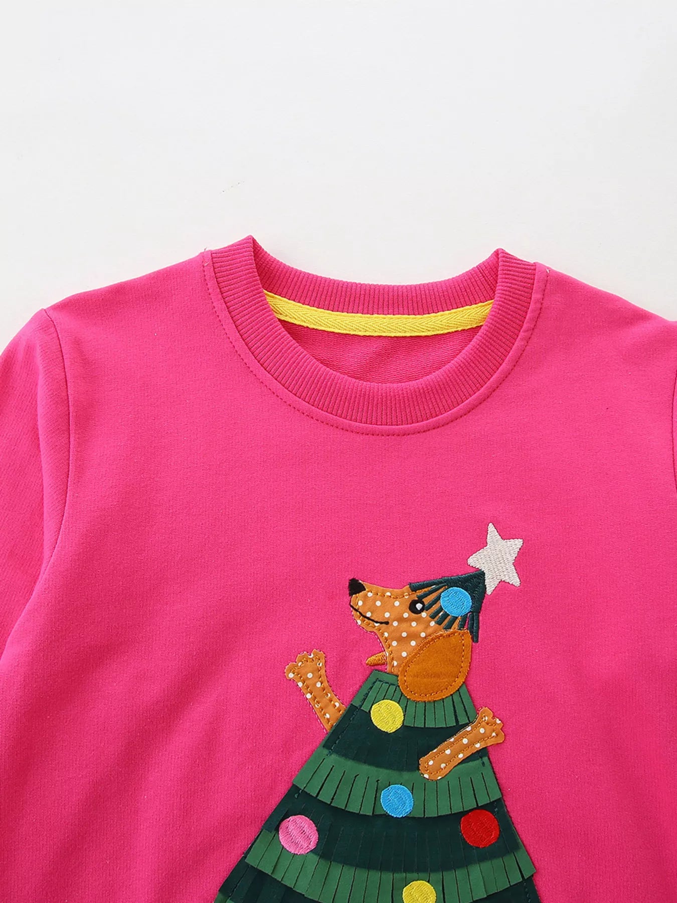 Children's hot pink cotton sweatshirt with a Christmas tree applique featuring a dog.