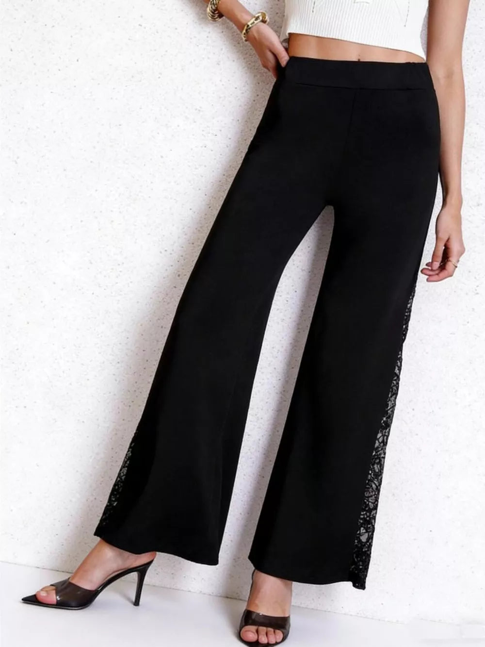 Black high-waist wide-leg pants with lace trim detail on the side seam.