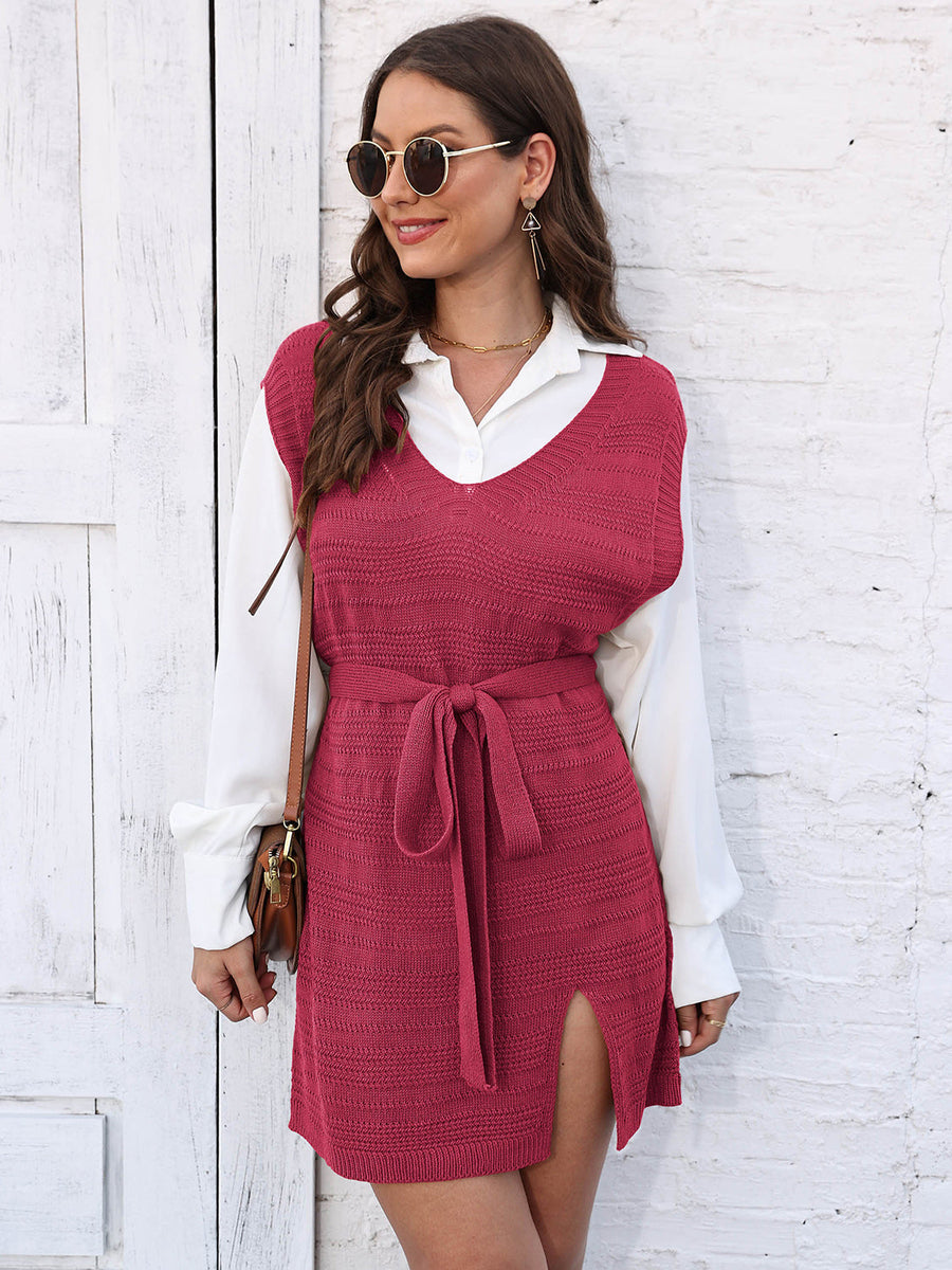 Deep Red knit vest dress with V-neck, tie waist, and side slit, worn over a white shirt.