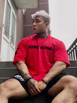 Red King Kong oversized graphic tee with bold black text and short sleeves.