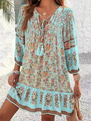 Light blue floral print mini dress with tassel tie neckline and tiered hem