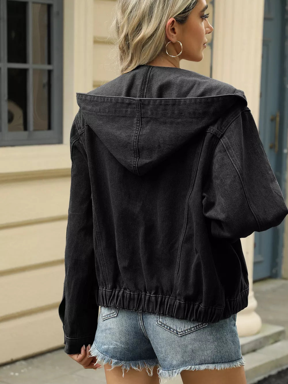 Black hooded denim jacket with elastic hem and cuffs, cropped length.