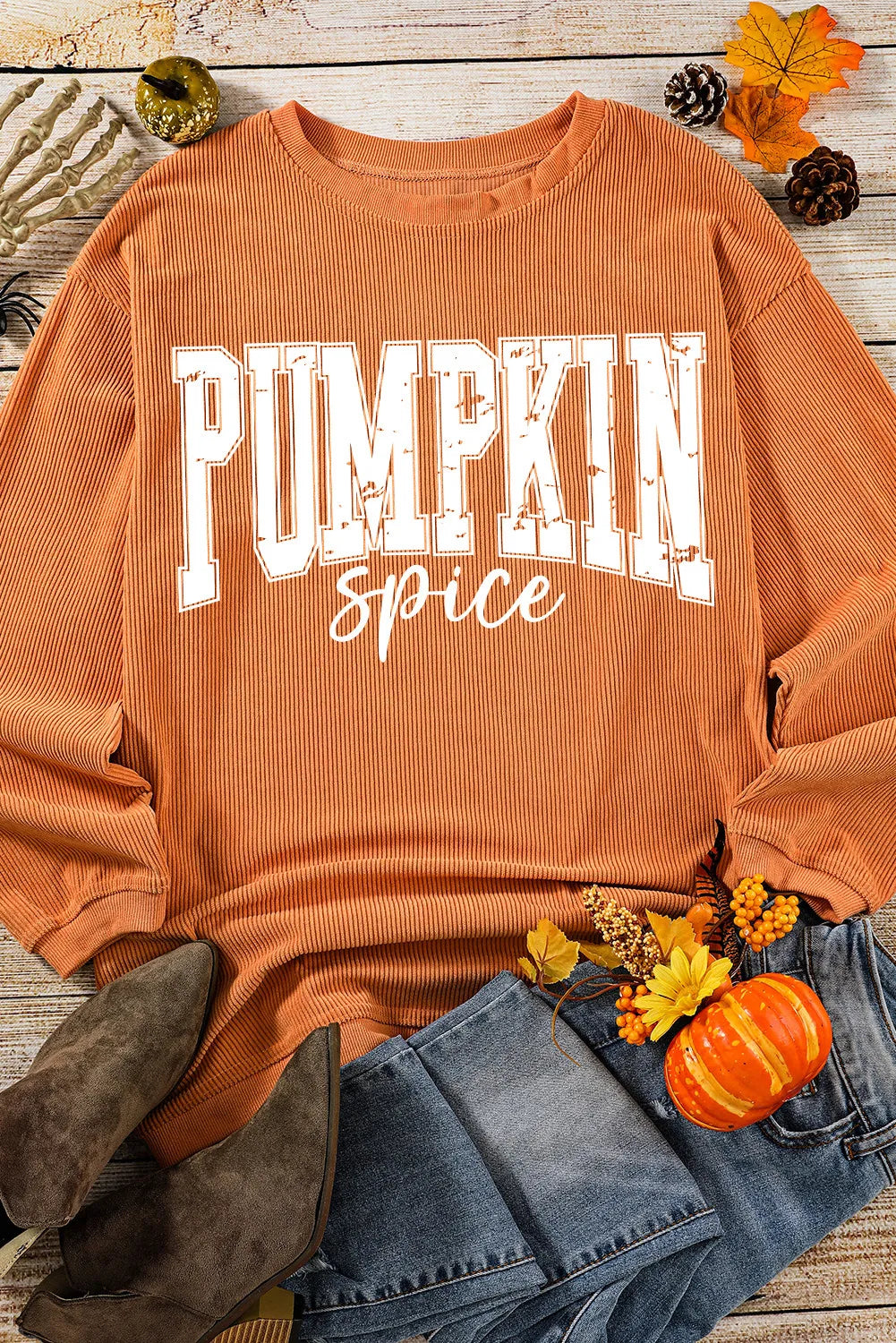 Textured corduroy sweatshirt in sherbet orange with "Pumpkin Spice" graphic.