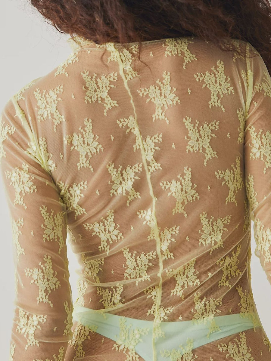 Sheer lime floral lace mock neck blouse with long sleeves.