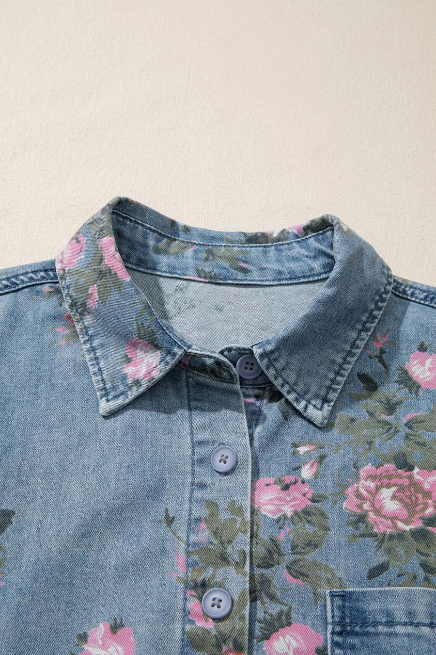 Denim button-up shirt with pink floral print, collared, long sleeve, cotton blend.