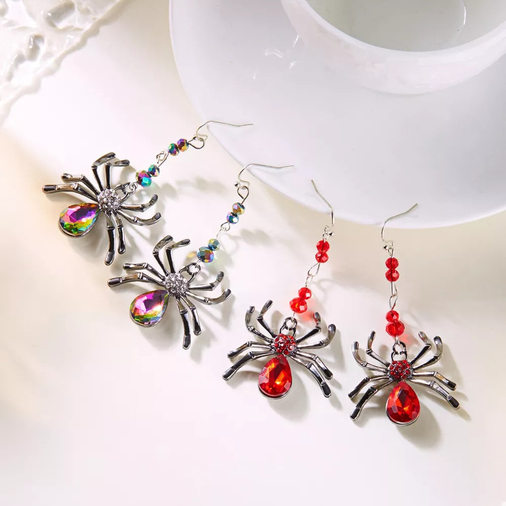 Red earrings featuring dangle and spider motif