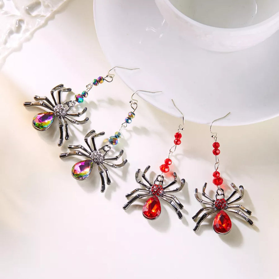 Red earrings featuring dangle and spider motif