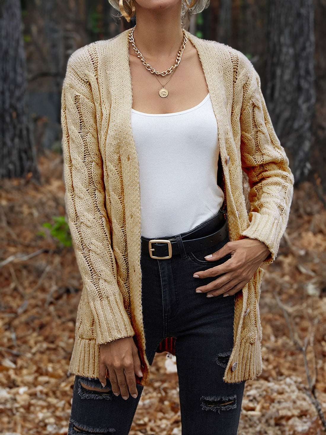 Cable knit cardigan in Pastel Yellow with long sleeves and open front, worn with a white tank top.