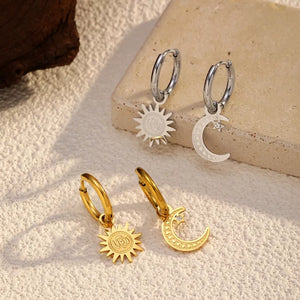 silver earrings featuring dangle charm and geometric