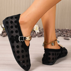 Black polka dot mesh slip-on flats with gold buckle detail and ankle strap.