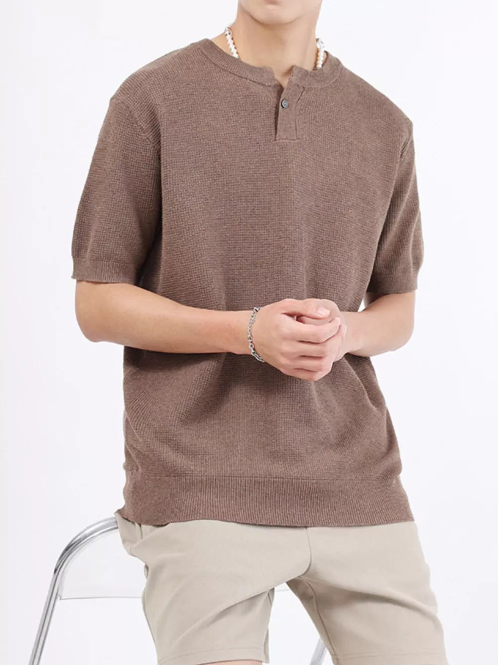 Men's taupe knit henley t-shirt with short sleeves and button placket.