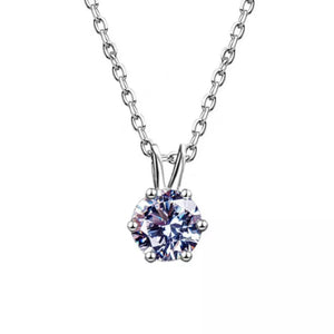 Elegant moissanite pendant necklace in sterling silver with a delicate chain.