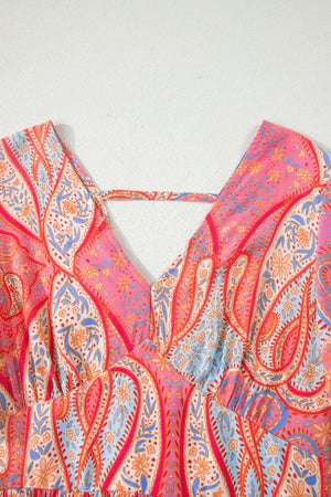Paisley print v-neck boho dress with criss-cross back detail in burnt coral and pink.