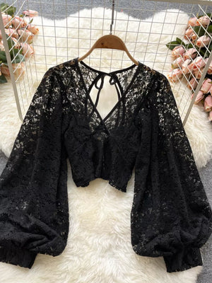Black sheer floral lace cropped shirt with balloon sleeves and tie-back detail.