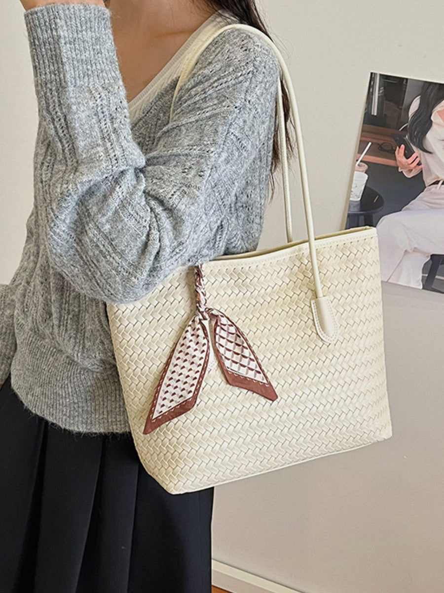 Beige handbag featuring woven texture and woven